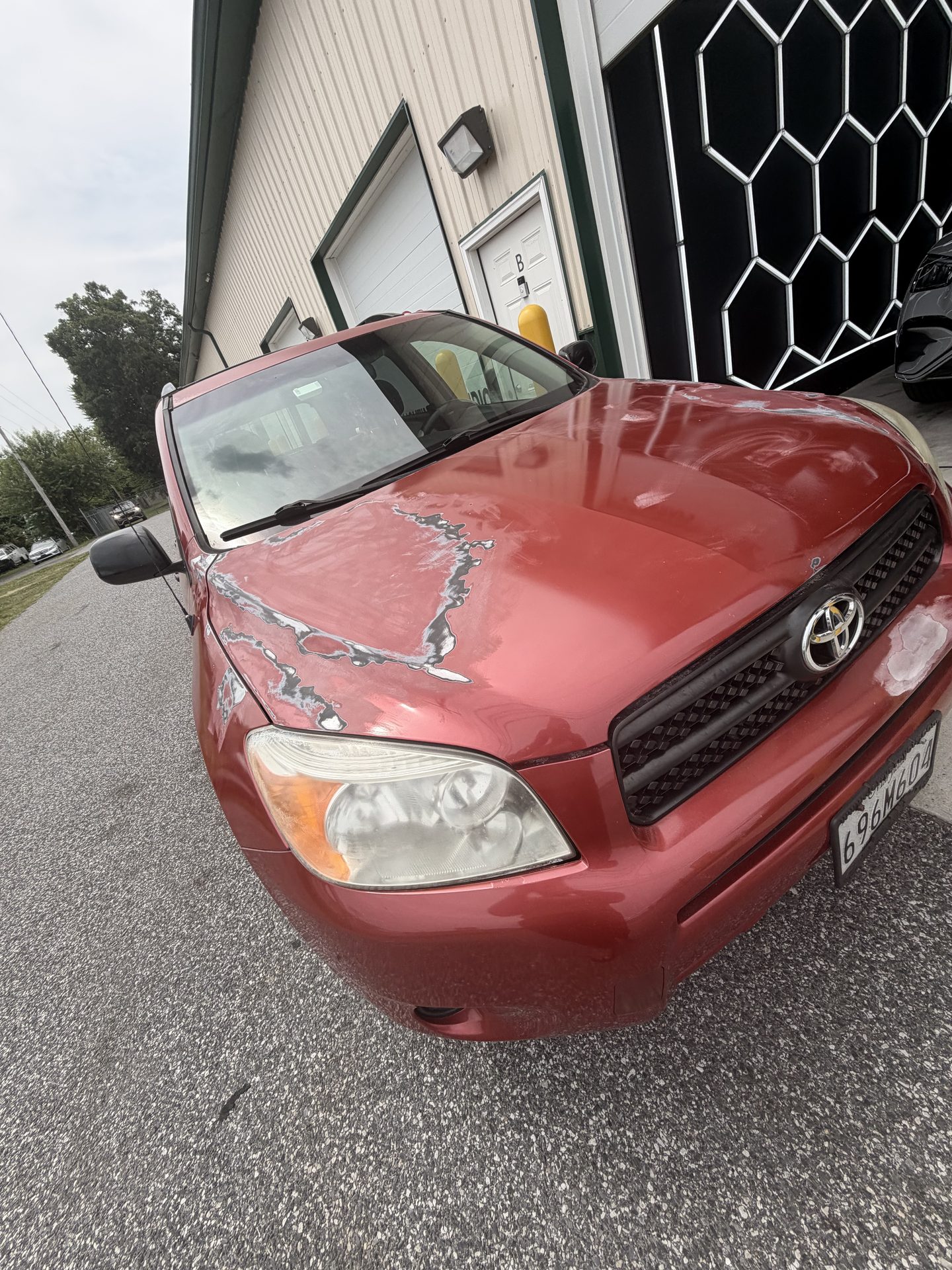 SUV hood with peeling, failing factory finish before work began