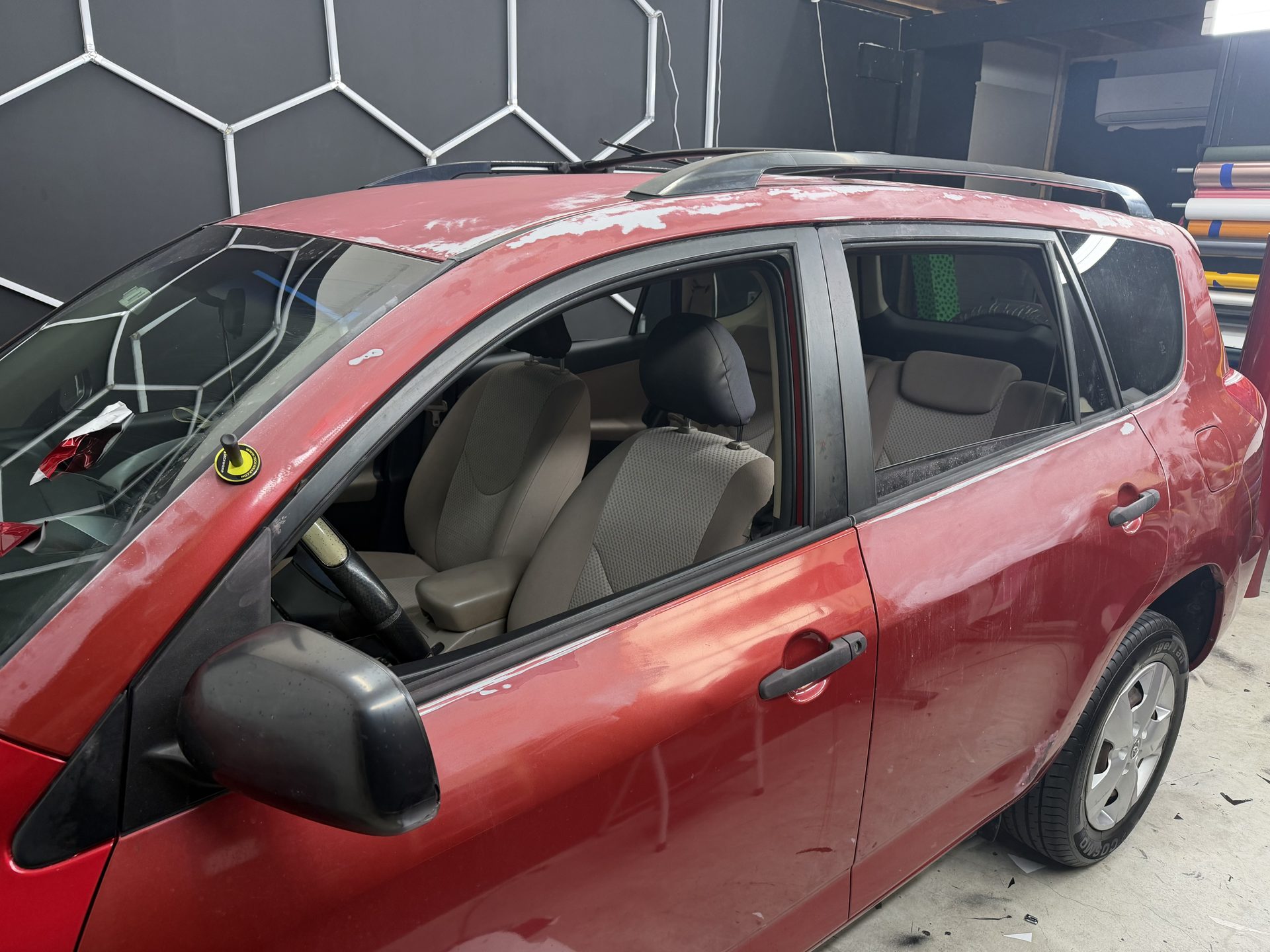 Red SUV part-way through a full vinyl wrap at the Pinnacle shop